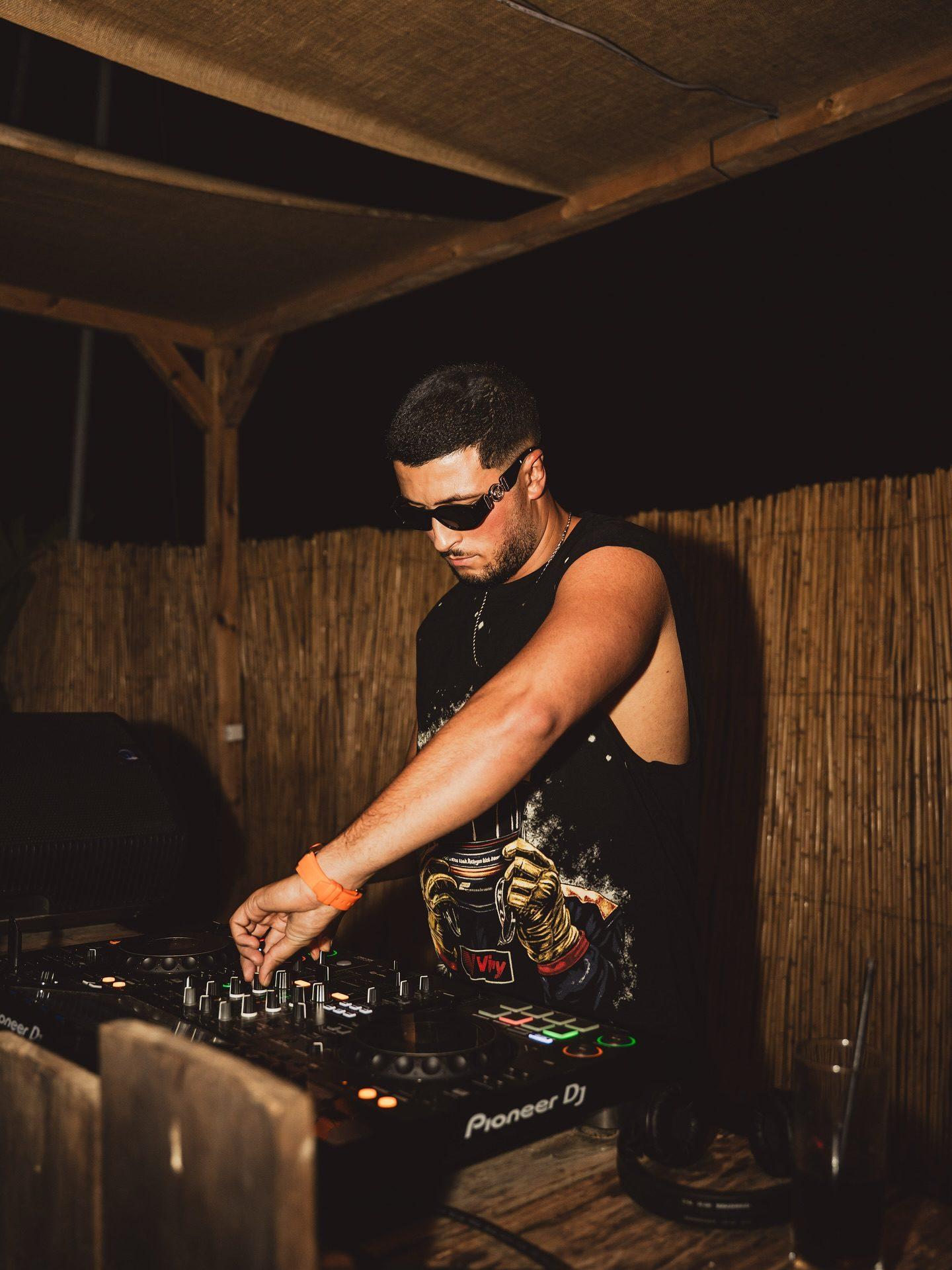Saffou in sunglasses playing an open-air set
